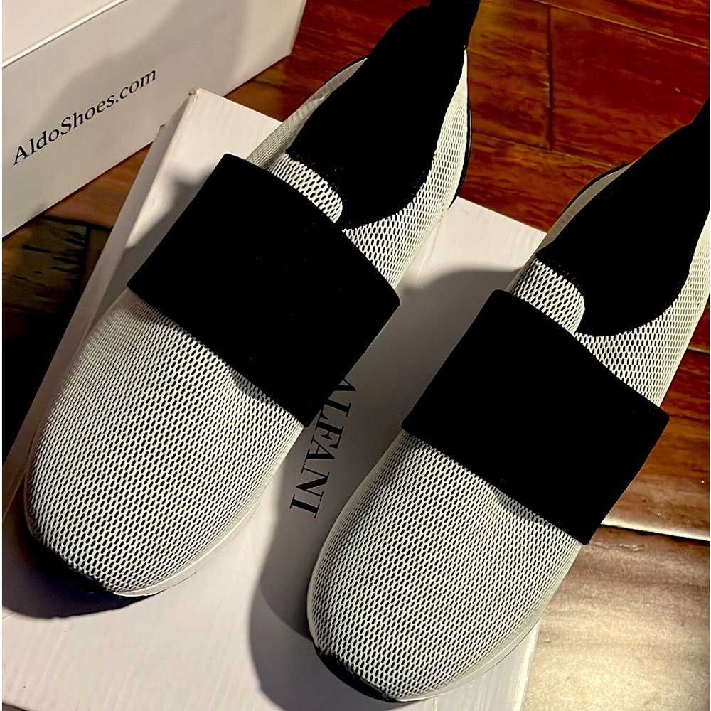 Color es blanco con negro , los tenis son de la marca Alfani